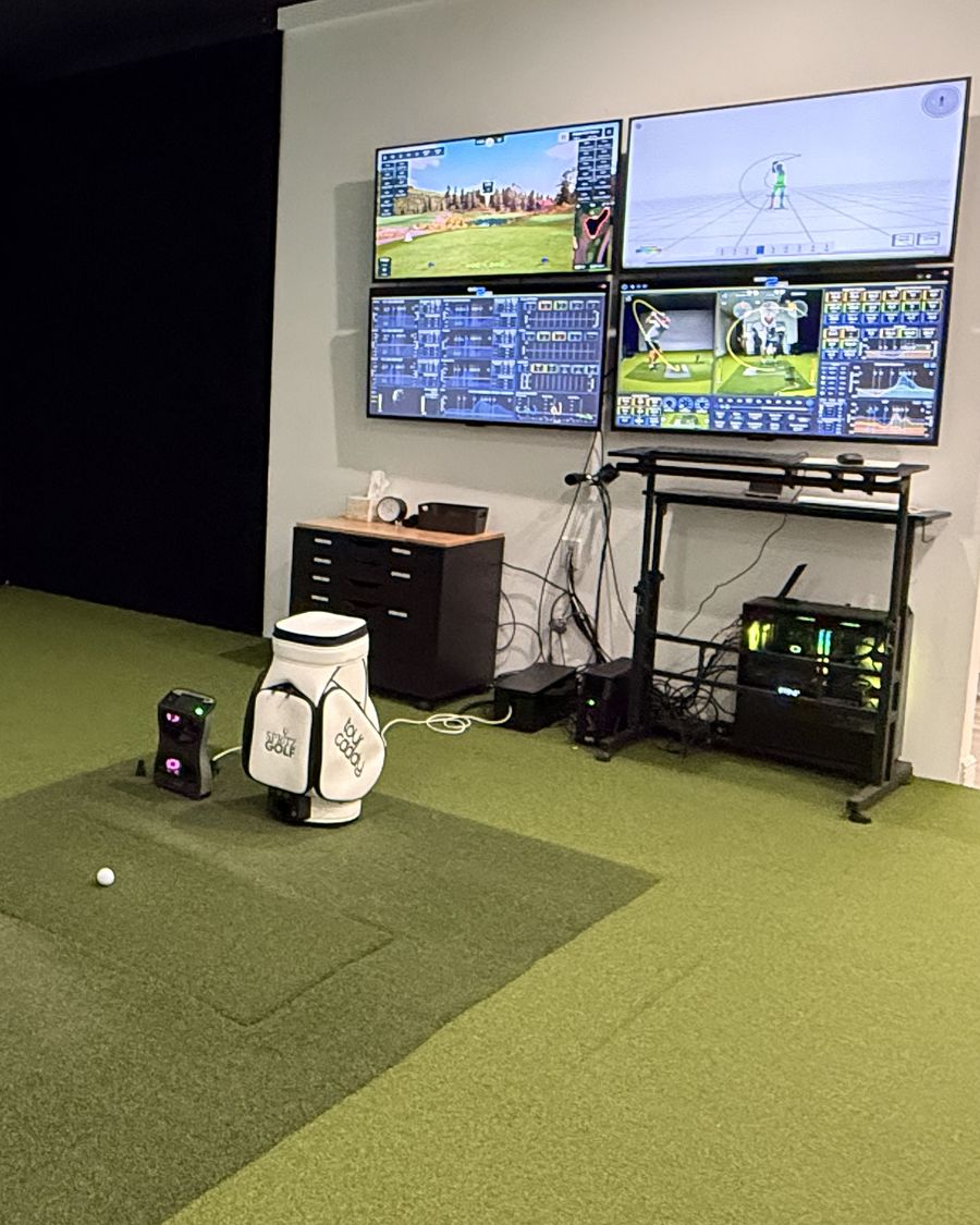 Spritz Golf bay with GC Quad launch monitor and wall of screens showing 3D motion capture and swing data